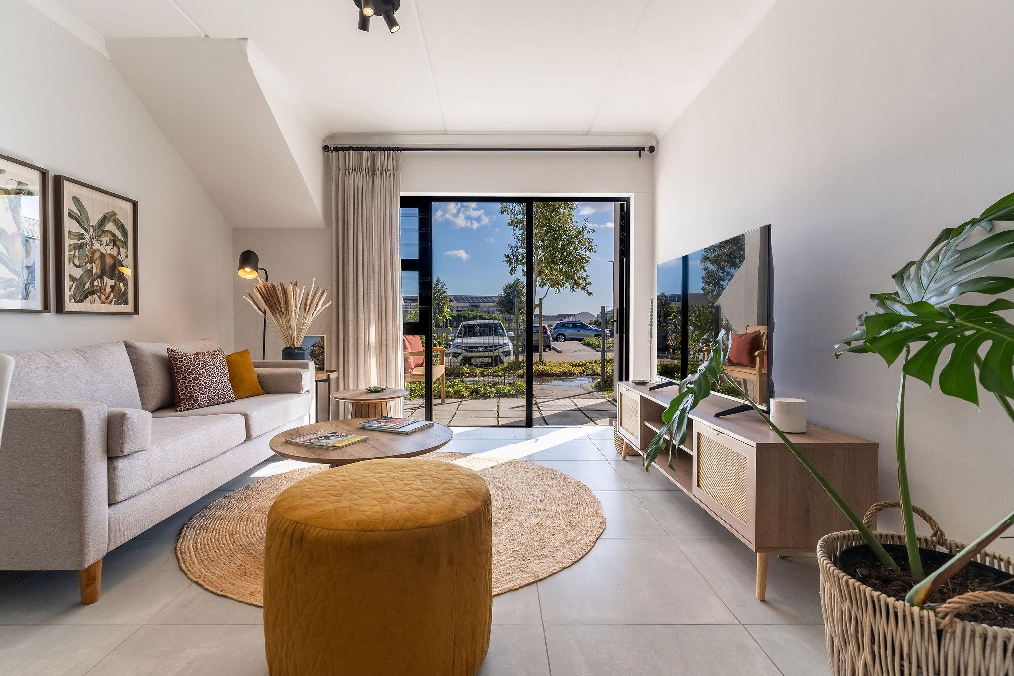Cape Vine living room with grey sofa and sliding doors onto the patio